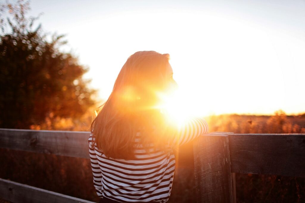 young woman looking into the sun
